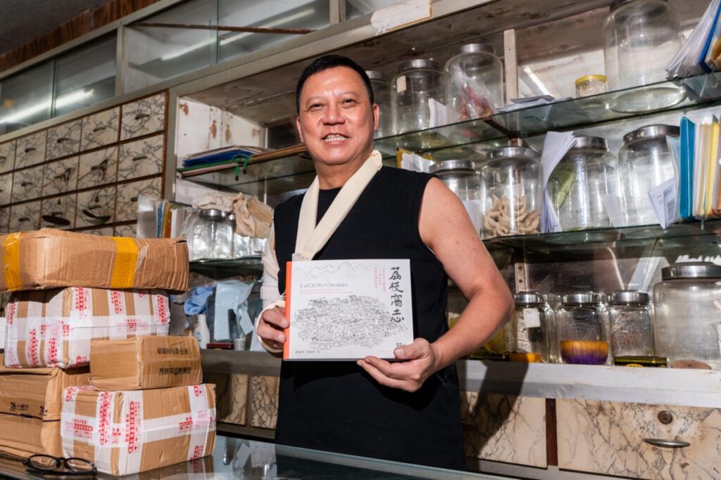 Lai Chi Wo Village Chief Tsang Wai Yip holds a copy of Lai Chi Wo Chronicles Hong Kong - RURAL ROOTS (NTU GO-FAR 2026)